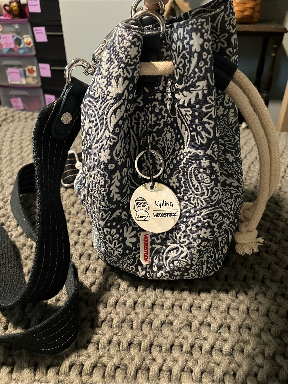 Kipling x Woodstock collaboration Aili drawstring bucket bag navy blue paisley